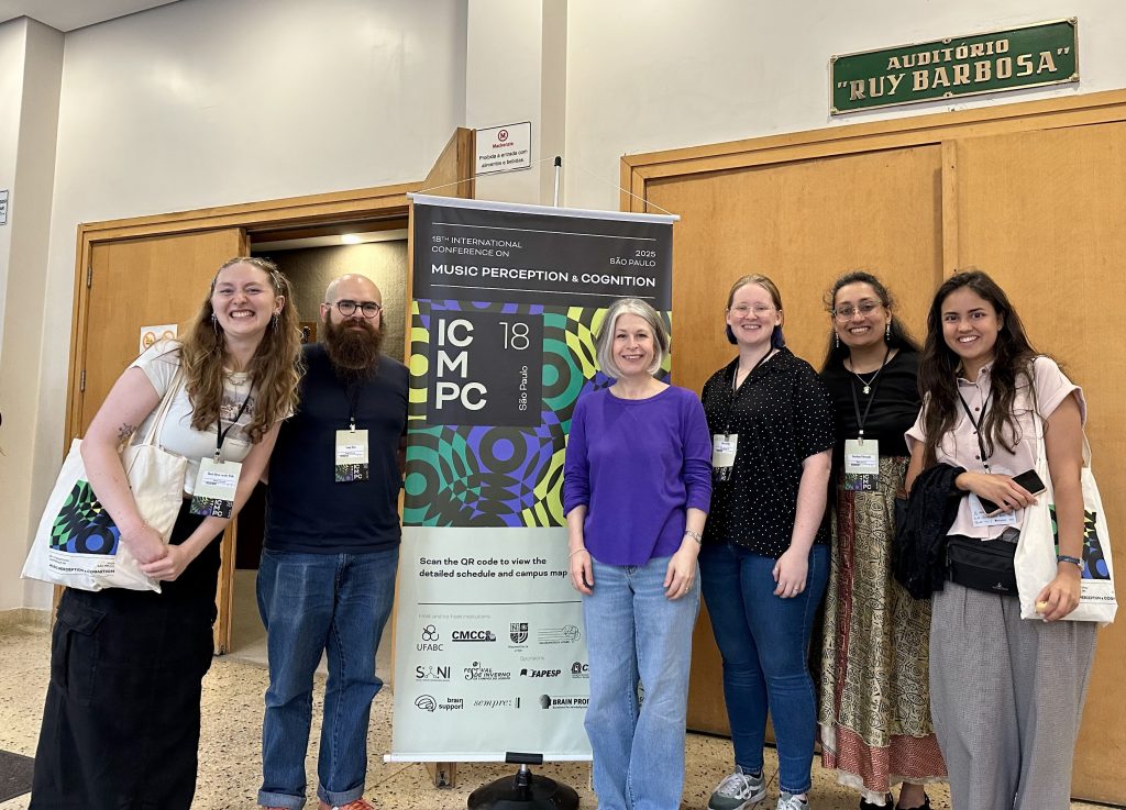 MPL members posing in front of the ICMPC18 sign in São Paulo, Brazil. (left to right: Hazel, Connor, Caroline, Aliya, Katie, Fruzsi)